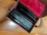 a box with a bunch of pens in it on a table