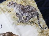 two cheetah and a cheetah running in the grass