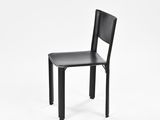 a black chair that is sitting on a white surface