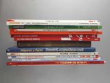 many books stacked on top of each other on a table