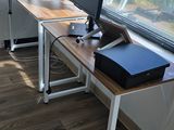 two computer monitors on a desk in a room