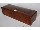 an old wooden box with a label on the lid