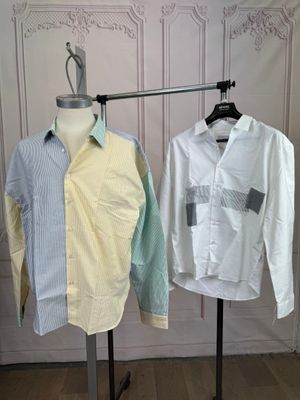two shirts hanging on a clothes rack in a room
