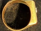 a gold ring with a black stone inside of it