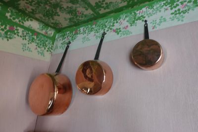 pots and pans hanging on the wall in the kitchen