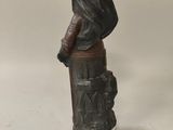 a statue of a man holding a flag on top of a fire hydrant