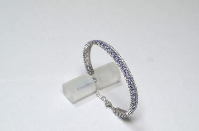 silver ring with blue and white stones on a white surface