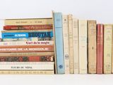 many books stacked on top of each other on a table