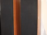 three speakers that are sitting on a wooden floor