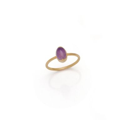 a gold ring with a purple stone in the middle