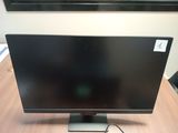 a computer monitor sitting on a desk with a mouse on it