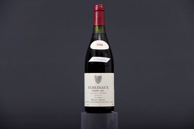 a bottle of wine sitting on top of a black table