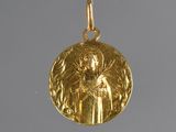 an image of a gold pendant with an image of an angel on it