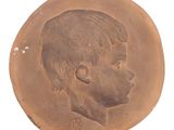 an old coin with a picture of a young boy on it