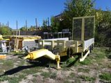 a yellow trailer that is sitting in the grass