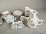 many cups and saucers that are sitting on a table