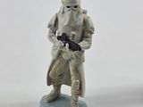 a toy figure of a star wars character holding a gun