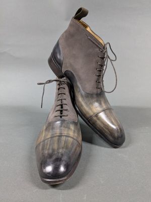a pair of men ' s shoes on a grey surface