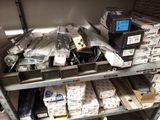 many boxes of electronics on a shelf in a room
