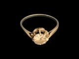a close up of a gold ring with a diamond on it