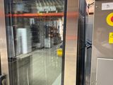 a large stainless steel refrigerator sitting in a warehouse