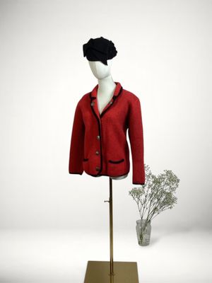 a mannequin wearing a red jacket and black hat