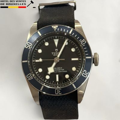 the watch is black and silver with a black dial