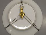 a white plate with a light bulb attached to it
