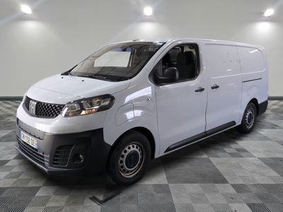 the white van is parked in a large room with a checkered floor