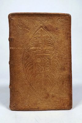an old brown book with a design on the cover