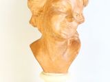 sculpture of a woman ' s head on a pedestal on a white background