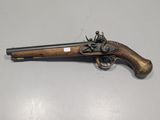 an old gun with a wooden handle on a table