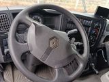 a steering wheel of a truck with a phone in it