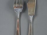 two spoons and a fork on a table