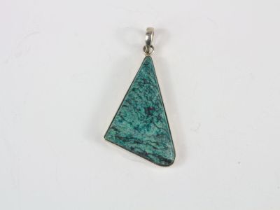 a triangle shaped pendant with a green stone in the center