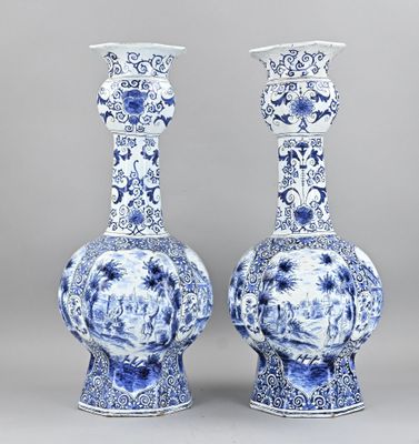 pair of blue and white vases with floral designs on them
