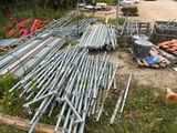 a lot of metal pipes and poles on the ground