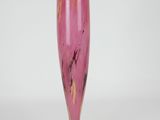 purple glass vase on white background with white wall in background