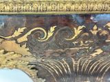 a close up of a gold and black vase with a lion on it