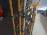 a pair of yellow crutts sitting on top of a yellow stand