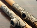 two wooden chopsticks sitting on a wooden table
