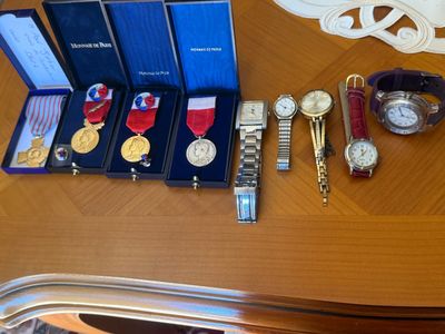 a lot of watches and other items on a table