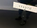a man holding a ruler with the word vauto written on it