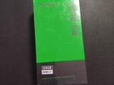 a green book sitting on top of a desk next to a keyboard
