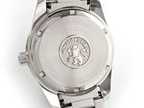 a close up of a watch on a white surface