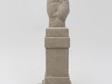statue of a hand with a fist on a pedestal