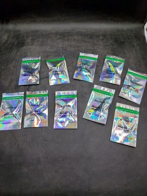 several packs of pokemon cards are sitting on a black surface