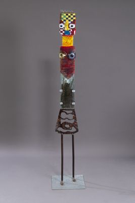 a sculpture of a totema made of glass and metal