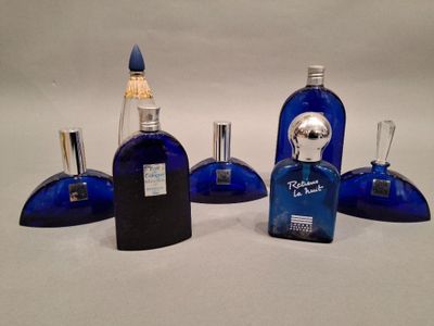 three blue glass bottles with a silver top and a silver top