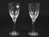 pair of etched wine glasses on a black background